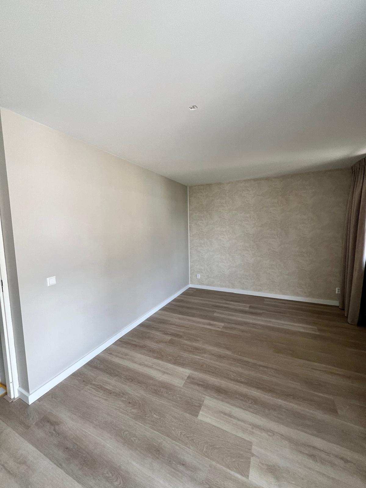 Slaapkamer met behangwand en net afgewerkte details